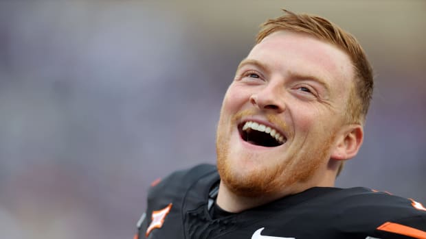 Oklahoma State's Alan Bowman (7) laughs as he stretches before the college football game between the Oklahoma State University Cowboys and the Kansas State Wildcats at Boone Pickens Stadium in Stillwater. Okla., Friday, Oct. 6, 2023.